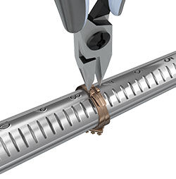 Pliers squeezing the adjustment pegs together